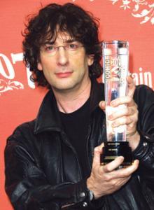 Neil Gaiman holding award