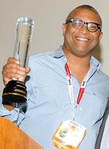 Reginald Hudlin holding award