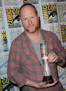 Joss Whedon holding award